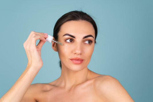 Woman applying serum to calm skin as part of an aftercare routine