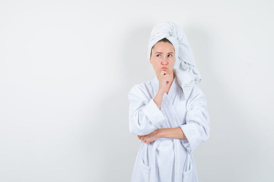 Woman using an LED light therapy face mask during a skincare session