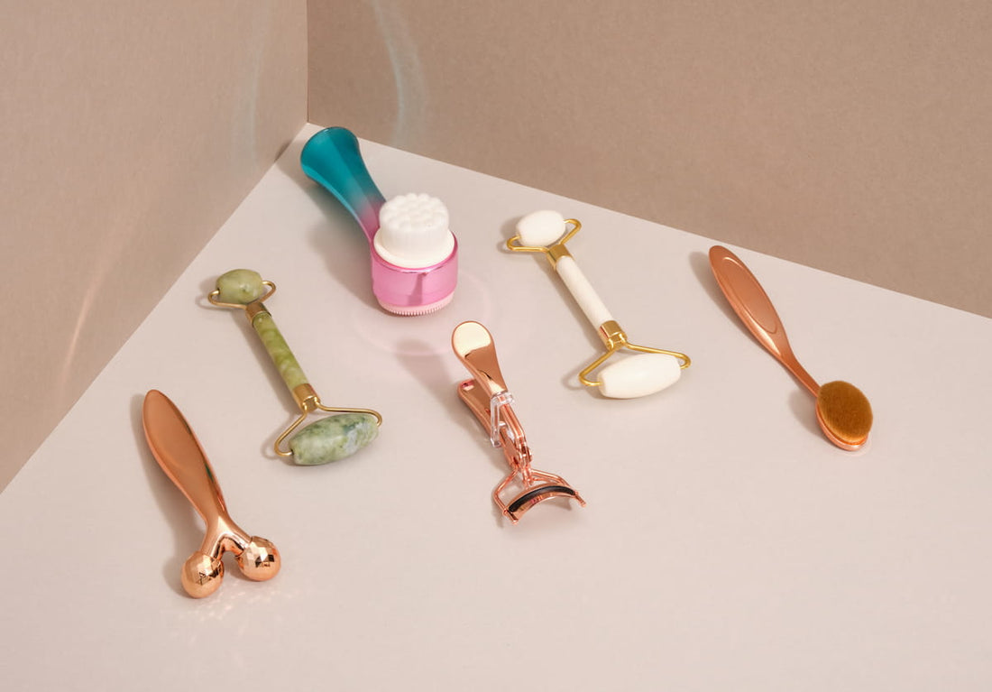 Selection of at-home facial tools including a derma roller laid out